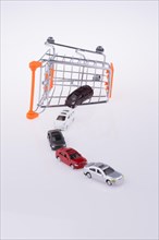 Cars coming out of a shopping cart on white background