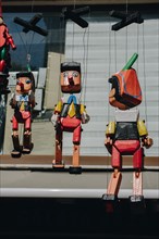 Wooden pinocchio dolls with long nose. Conceptual fairy tale character