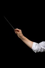 Arm of male conductor with baton isolated on black background