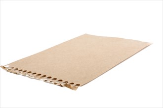 Sheet of brown torn notepaper on a white background