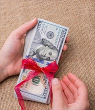Banknote bundle of US dollar tied with colorful a ribbon