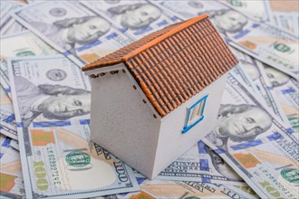 Model house is placed US dollar Banknotes on spread on the background