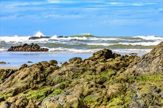 Rocky beach with waves crashing against the rocks in Serra Grande on the coast of Bahia