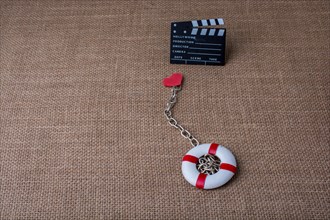 Heart attached to a life preserver and a cinema clapper