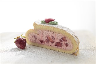 Delicious fruity sponge roll with strawberry filling Strawberry Quark Sponge Roll sprinkled with icing sugar