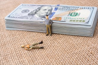 Men figurines found beside the bundle of US dollar banknote