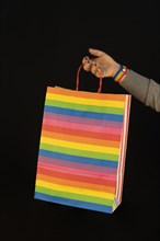 Shopping lgbt bag in the woman hands. Joy of consumption. Purchases