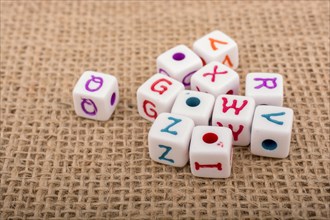 Colorful alphabet letter cubes on a linen canvas