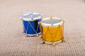 Little colorful toy drums on a canvas background