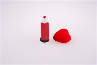 Red heart near a red pen