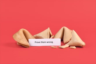 Fortune cookies with motivational text saying 'Prove them wrong' on red background