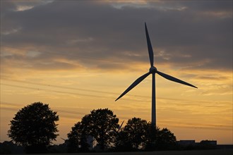 Wind power plant in front of evening sky