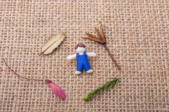 Boys figurine and flowers and leaves on canvas