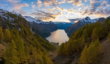 Aerial view after sunset over the autumnal forest at Lago di Luzzone in Valle di Blenio