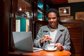 Business woman of African ethnicity in a coffee shop