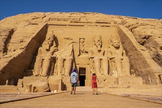 A tourist couple visiting the Abu Simbel Temple in southern Egypt in Nubia next to Lake Nasser. Temple of Pharaoh Ramses II