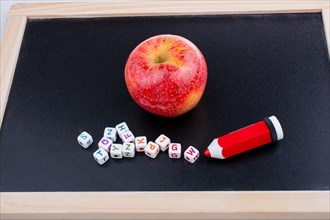Back to school theme with a red apple and board