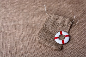 Life preserver on a sack on canvas background