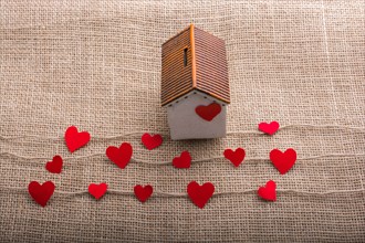 Heart shaped icons and paper house on linen threads