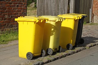 Yellow bins for plastic waste standing on the street
