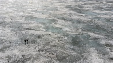 Aerial of fisherman walking on lake Tengiz
