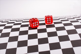 Red dice on a checked background