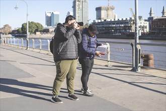 Couple of friends exploring Puerto Madero