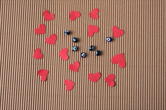 Love concept with red paper hearts and evil eye beads beads