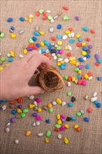 Basket of colorful pebbles spill on background