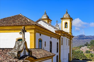 Colorful baroque church with mountains in the background in Ouro Preto city in Minas Gerais