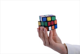 Child holding a Rubik's cube in hand on a white background