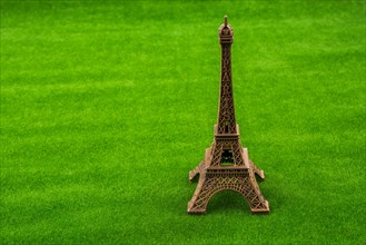 Little Eiffel Tower model on green grass