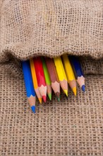 Color Pencils in a linen sack on canvas