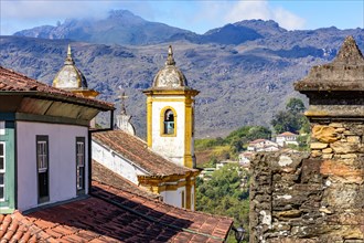 Historical baroque church with mountains in the background in Ouro Preto city in Minas Gerais