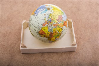 Model Globe placed on a brown background