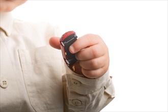 Baby hand holding a red car on a white background