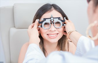 View of specialist checking vision of patient with trial frame in ophthalmology clinic. Vision check with optometrist trial frame on patient
