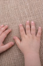 Toddler hand with canvas linen background