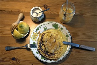 Pancakes with apple sauce and lemon on a plate