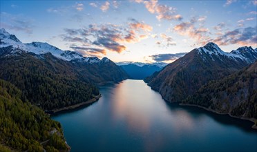 Aerial view after sunset over the autumnal forest at Lago di Luzzone in Valle di Blenio