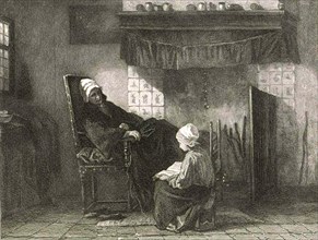 Old woman in an armchair in front of a fireplace