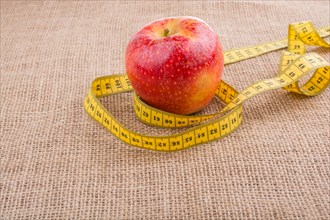 Health and diet concept with apple with a measurement tape