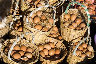 Organic fresh farm eggs in the straw basket