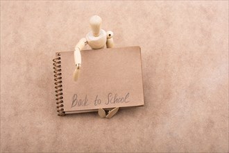 Back to school lettering on a notebook in arm