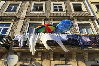 Colourful parasols and clothesline on a balcony in the old town of Coimbra