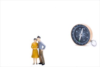A couple by the side of a globe with a compass on isolated white background