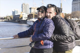 Tourist gay couple posing in Puerto Madero