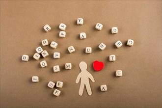 Letter cubes of made of wood and man figurine and heart shape