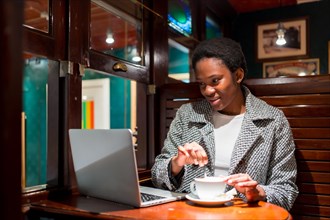 Business woman of African ethnicity in a coffee shop