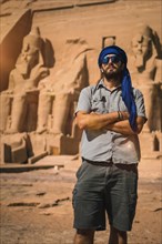 A young tourist with a blue turban visiting the Abu Simbel Temple in southern Egypt in Nubia next to Lake Nasser. Temple of Pharaoh Ramses II
